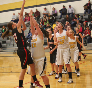 Tyler Workman shoots against Highland. Also shown are Tanna Schlader, Taylor Heitman (behind Highland’s #20) and Callie Mader. Photo by Steve Wherry.