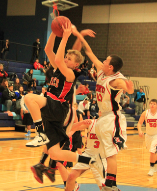 Marcus Higgins drives in for a lay-up against Lakeside.
