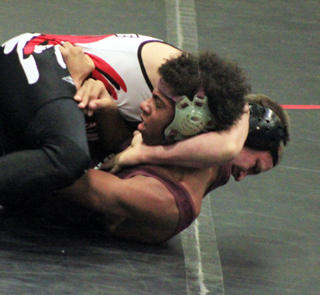 Hunter McWilliams is about to pin Kamiahs Tayler McAllister during the Kamiah Tournament this past weekend. McWilliams wound up taking first place in the 132 weight class.