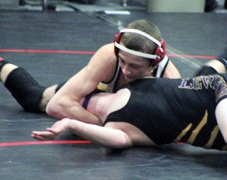 Tyler Ross is about to score a pin against Lewistons Ty Hendren at the Kamiah Tournament Saturday.