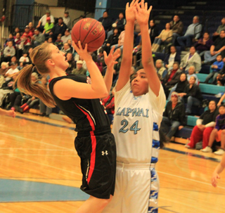 Keely Schmidt scores during a second quarter rally against Lapwai. At right are Brooke and Kayla Schumacher.