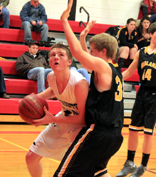 Josh Lustig looks for an opening to shoot the ball against Highland.