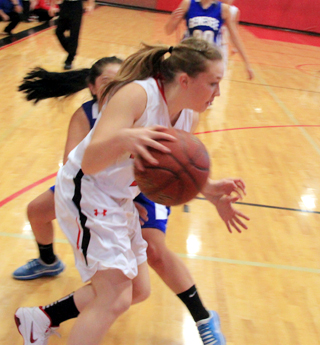 Keely Schmidt drives toward the hoop.