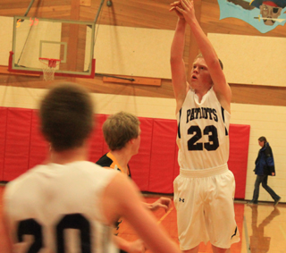 Summits Nathan Beckman puts up a 3-point shot against Highland. #20 is Josh Lustig.