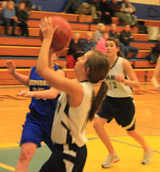 Rachel Waters scores against Nezperce. Megan Seubert is shown in the background.