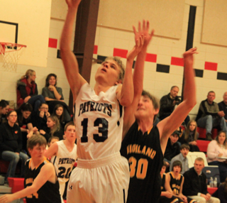 Shane Stubbers got inside of the Highland defense for a lay-up. In the background is Josh Lustig.