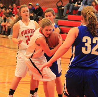 Tanna Schlader battles to keep the ball as Brooke Schumacher watches.