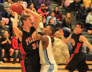 Lucas Arnzen looks to pass in the Lapwai game. At right is Seth Chaffee.