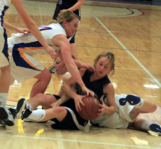 Abi Chmelik battles for the ball in a big scrum on the floor during Summits game with Nezperce at District.