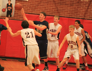 Prairie defenders surround a Grangeville player. From left are Seth Chaffee, Jake Bruner, Rhett Schlader and Tyler Hankerson.