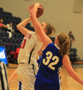 Kendall Schumacher puts up a shot against Genesee. She came off the bench in that game to hit 5 of 7 shots and score 11 points.