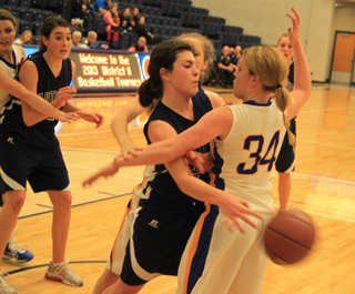 Megan Rehder makes a wrap-around pass against Nezperce. At left is Megan Seubert and in the background is Sarah Chmelik.