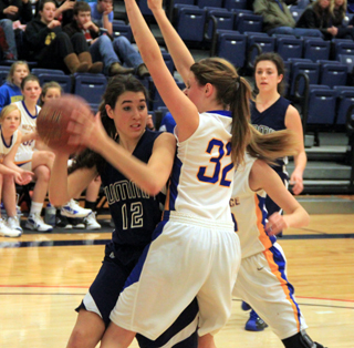 Megan Seubert looks to pass against Nezperce. In the background is Megan Rehder.