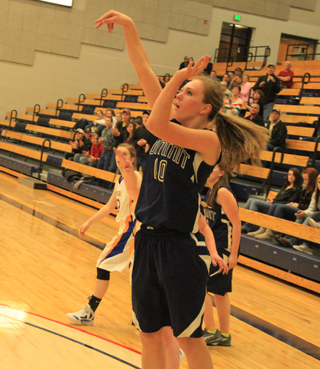 Sarah Chmelik puts up a jump shot against Nezperce. Hidden behind her is Rachael Frei.