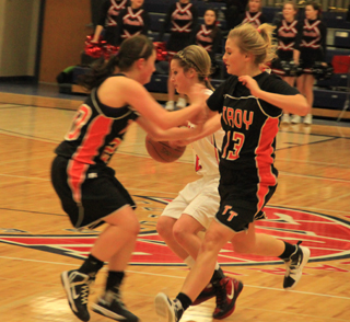 Callie Mader makes a quick zig to the right and made these two Troy defenders run into each other during last Fridays game.