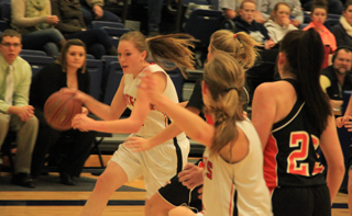 Keely Schmidt drives the ball against Troy. In the foreground is Tanna Schlader.