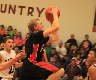 Marcus Higgins drives into the lane for a basket at Kamiah.