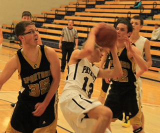 Shane Stubbers pulls down an offensive rebound and despite looking off-balance was able to gather himself and score the putback. At left is Matthew Schwartz and at right is Michael Waters.