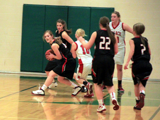 Defense has been Prairies calling card all year. Here Tanna Schlader has just come up with a steal in the play-in game at Wallace where Prairie forced an amazing 48 turnovers. Others from left are Shelby VonBargen, Brooke Schumacher and Callie Mader.