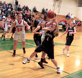 Tanna Schlader battles for a rebound in the Wallace game and appears to be getting fouled. Also shown are Shelby VonBargen and Brooke Schumacher.
