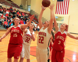 Brooke Schumacher reaches for a rebound against Grace. At left is Taylor Heitman.