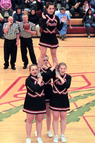 Katherine Nida is supported by Kirsten Latimer, Holli Uhlorn and Emily McHugh during a cheer at the Kamiah game.