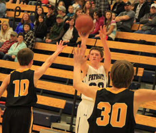 Josh Lustig shoots a 3-pointer against Highland at District. He had a huge double-double with 18 points and 21 rebounds. At right is Matthew Schwartz.