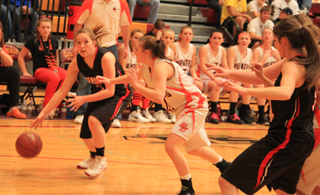 Keely Schmidt handles the ball against Butte County as Shelby VonBargen posts up at the right.