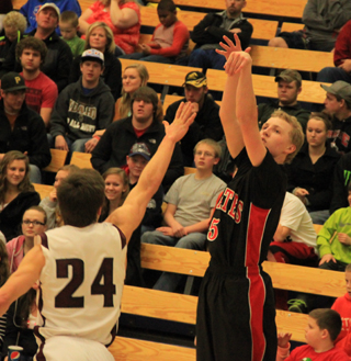 Marcus Higgins shoots for one of his seven 3-pointers against Kamiah at District Monday. He came up 1 short of tying his cousin Beau Schladers school record of 8 set against Nezperce 2 years ago.