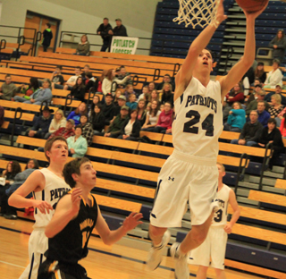 Michael Waters goes for a lay-up against Highland at District. At left is Josh Lustig and in the background is Nathan Beckman.
