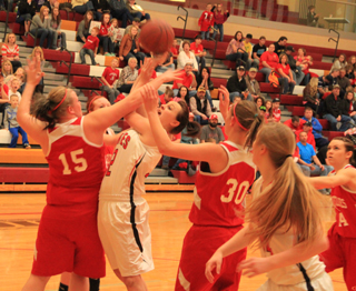 Taylor Heitman was fouled on this shot attempt and made both free throws in the Grace game. At right is Kayla Schumacher.