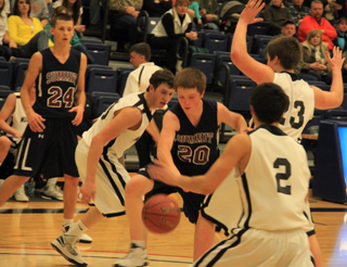 Josh Lustig tries to get through the Deary defense for a shot. At left is Michael Waters.