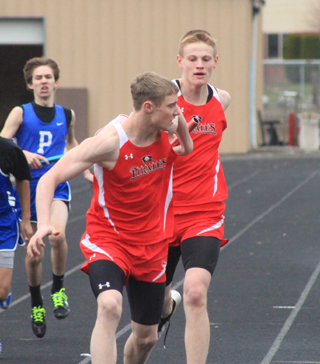 Lucas Arnzen takes the baton from Jake Bruner in the 4x200 relay.