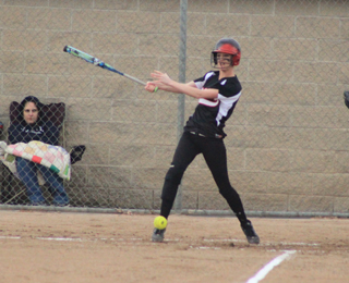Leah Holthaus sends the ball the other way while hitting lefthanded against Kellogg.