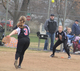 Shortstop Tanna Schlader throws to 1st baseman Kendall Schumacher for a putout in the first game against Kellogg.