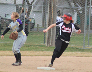 Taylor Nuxoll looks into the outfield as she rounds second on her way to a first inning triple against Kellogg.