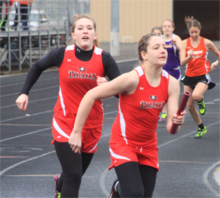 Keely Schmidt has just handed off to Shayla VonBargen in the 4x200 relay at Lapwai a week ago.