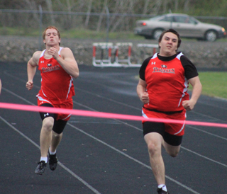 Victor Schmidt, left, and Dakota Wilson near the finish in a 200 meter dash heat.