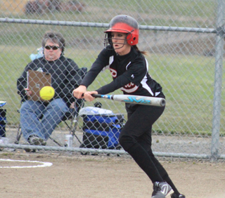 Leah Holthaus looks to slap-hit the ball and beat out an infield hit.