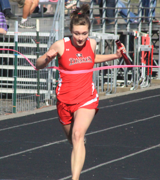 Krystin Uhlenkott breaks the tape in first place at the end of the 4x200 relay at the White Pine Meet.