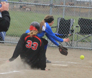 After a leadoff triple in the 7th inning, Taylor Nuxoll slides home safely following a wild pitch in the Orofino game.