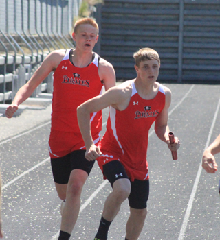Jake Bruner gets the baton to Lucas Arnzen in the medley relay at the Area Best meet.