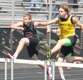 Ryan Glimp was neck and neck with a Timberline runner in a junior high track meet at Kamiah.