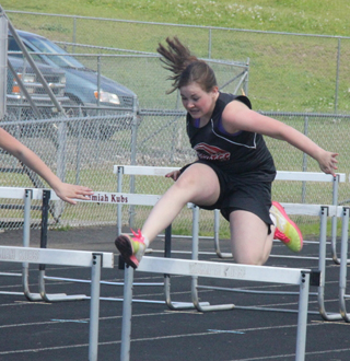 Sydney Bruner goes over the hurdles at the Junior High meet Saturday.