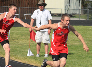Dylon Bruegeman gets the baton to Hunter McWilliams in the 4x100 relay.