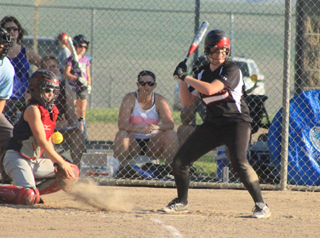 Kendall Schumacher watches a pitch bounce in the dirt. She and Mackenzie Rieman drew back-to-back bases loaded walks that tied the score and then put Prairie ahead.