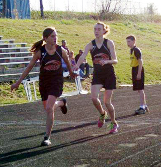 Kori Pentzer hands off to Kylie Tidwell in a relay.