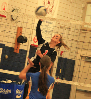 Leah Holthaus spikes the ball at the net against Nezperce at the Grangeville Jamboree.
