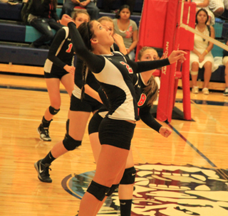 Natasha Gimmeson reaches to make a spike. Behind her are Krystin Uhlenkott, Kayla Schumacher and Hailey Danly, who set the ball for Gimmeson.