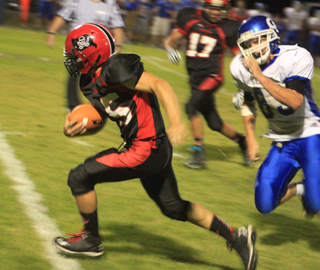 Hunter McWilliams breaks free for a 30 yard touchdown run. In the background is Tyler Hankerson.